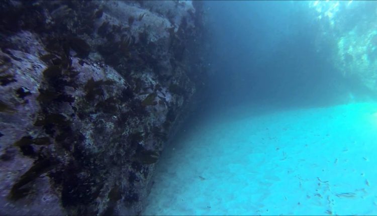 Diving through the Devil's Bellows, Kynance Cove, Cornwall, England
